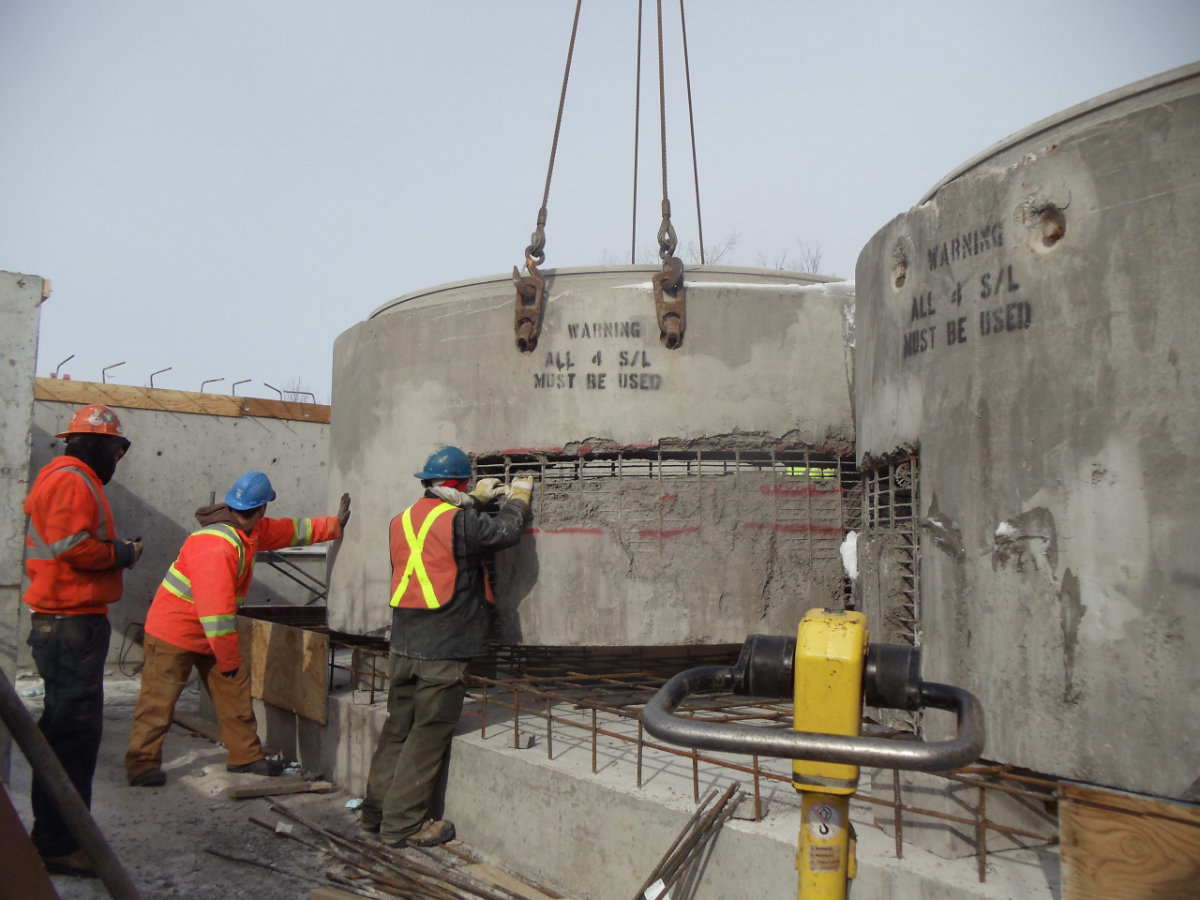 Construction crew installing a large concrete tank for water and wastewater construction in Ontario.